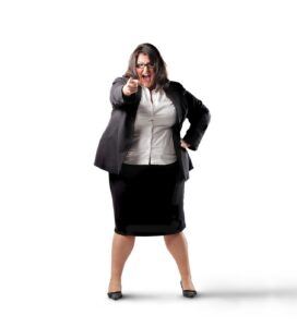 Businesswoman in a suit pointing forward on a white background