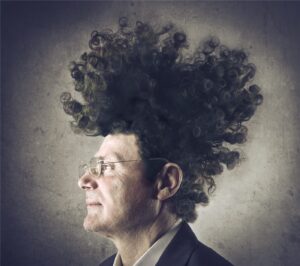 Man in profile with big afro hair and glasses