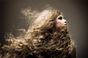 Profile of a woman with windswept curly hair